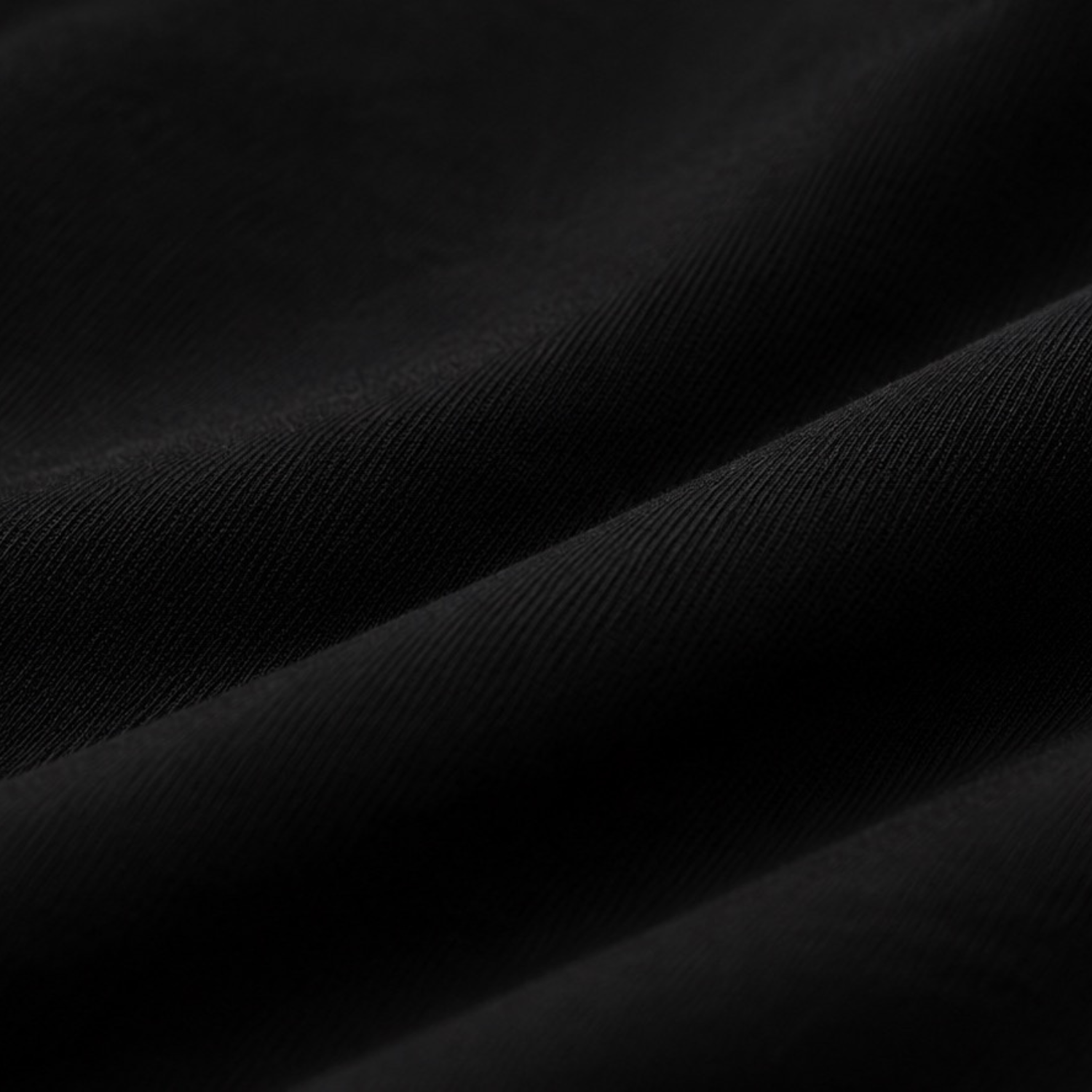 A close-up of draped black t-shirt cotton fabric