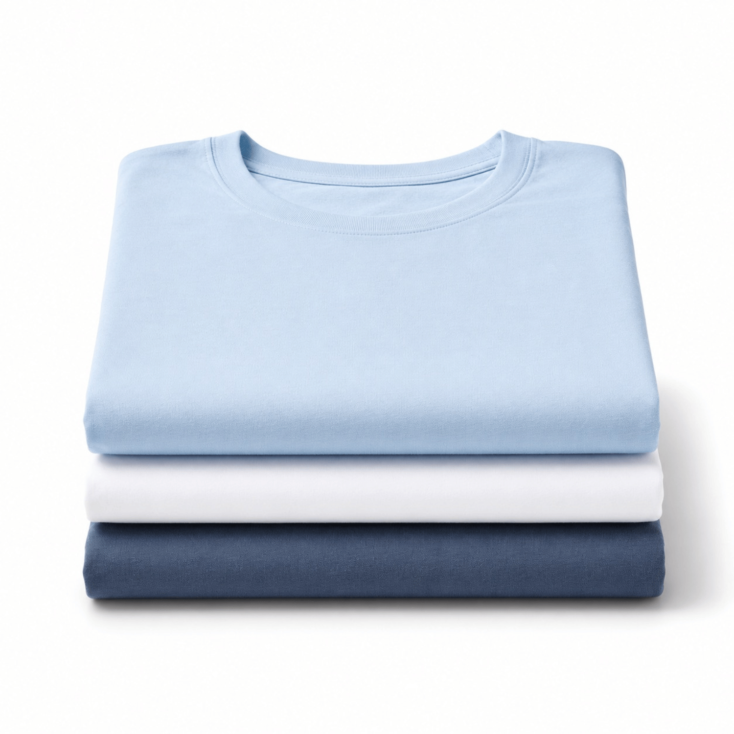 Three neatly folded crewneck t-shirts stacked vertically on a white background, shown in light blue, white, and indigo blue.